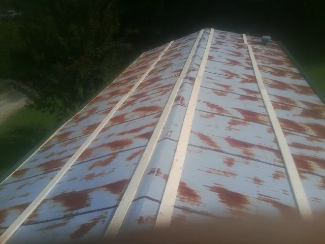Rusted metal roof panels with new wood purlins before replacement — Storm Damage Roof Repair in Hodgenville by Roofing Brothers