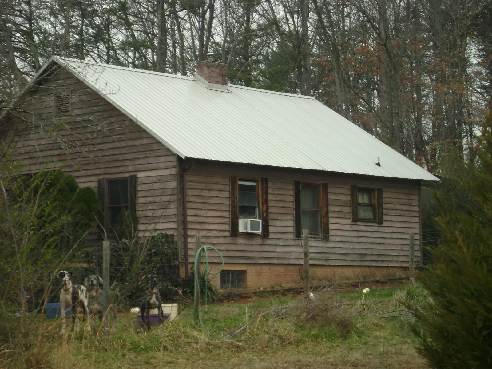 White metal roof on an old wood sided farmhouse, from a Metal Roof Installation job in Hodgenville